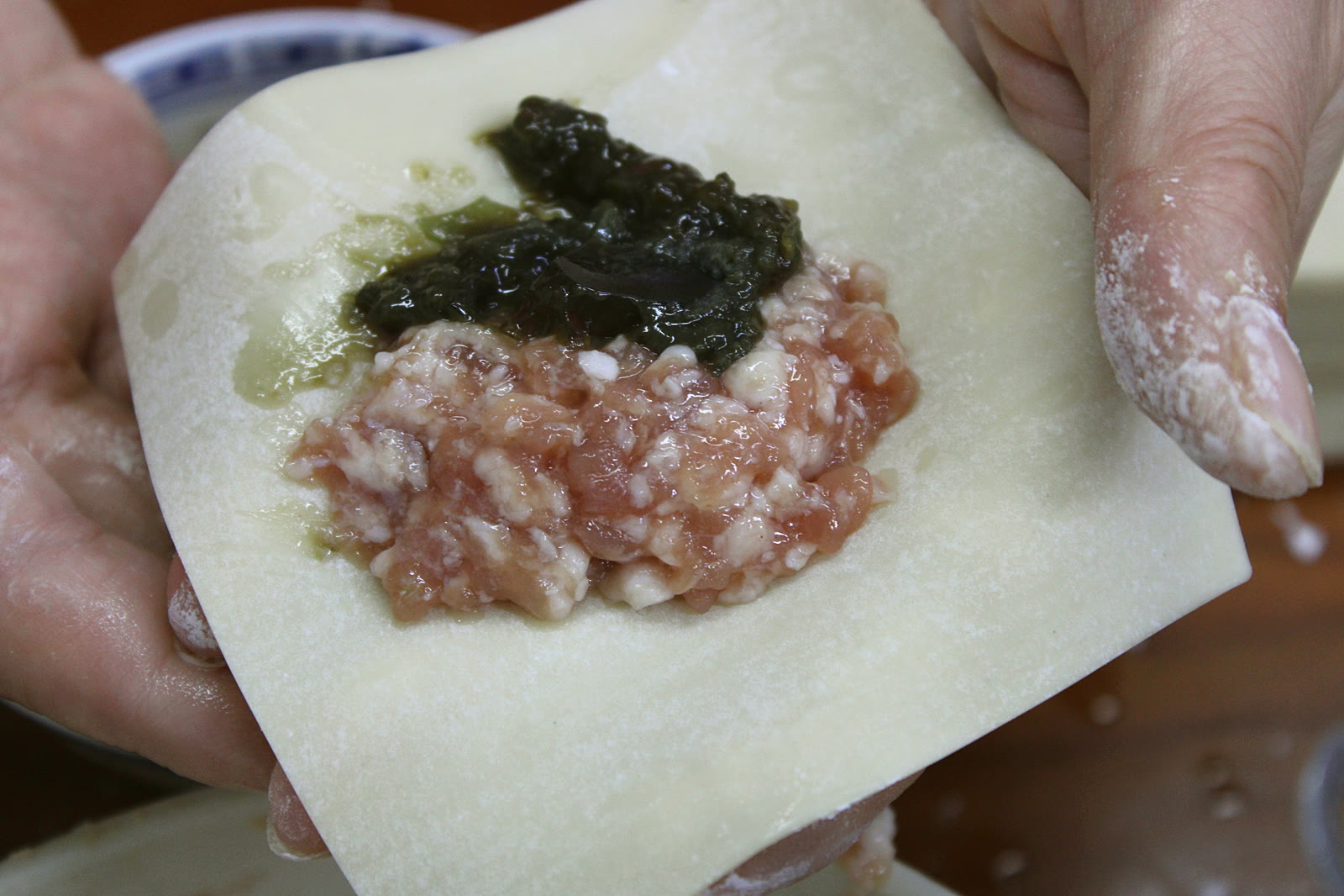 Wrapping century egg & pork wontons by hand
